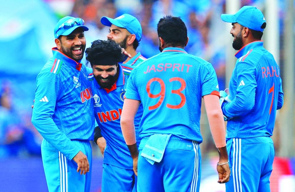 India’s Ravindra Jadeja (second left) celebrates with teammates after taking a catch to dismiss Bangladesh’s Mushfiqur Rahim off the bowling of Jasprit Bumrah in Pune on Thursday.  (Reuters)