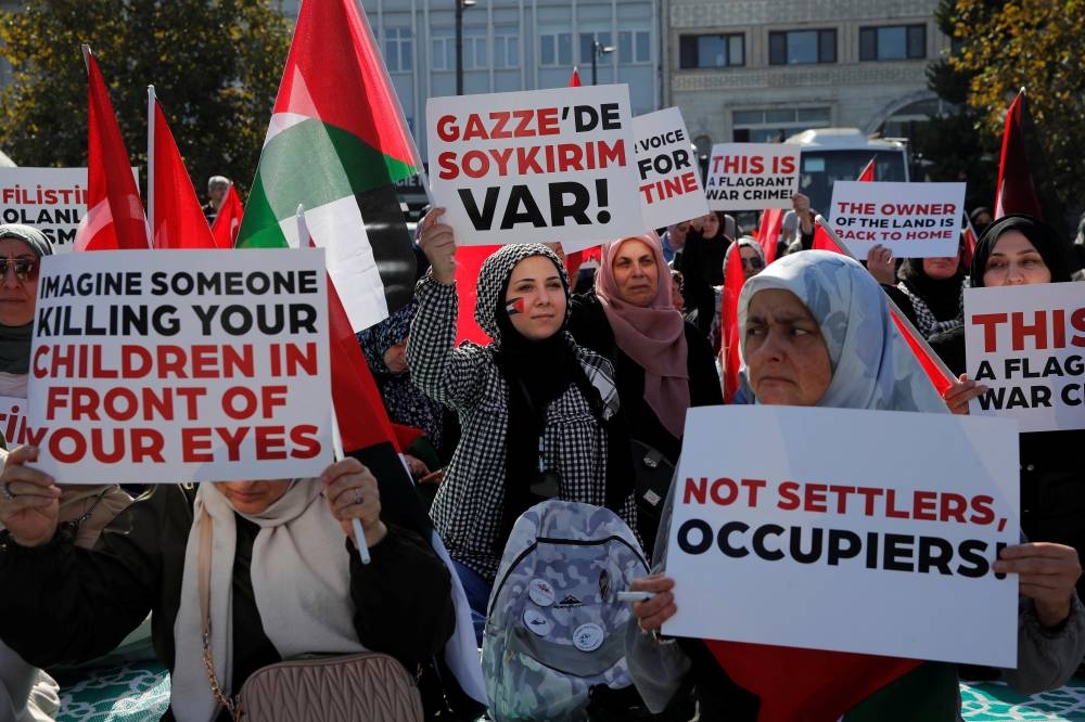 Pro-Palestinian demonstrators take part in a sit-in protest as the conflict between Israel and Hamas continues, in Istanbul, TurkeyFriday. REUTERS
