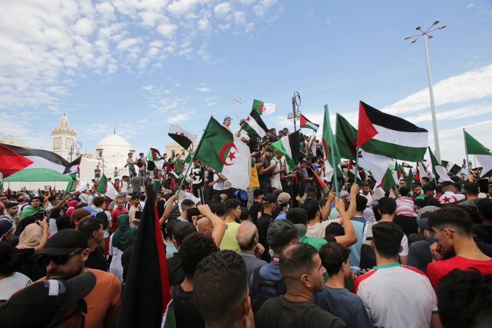 People protest in support of Palestinians in Gaza, as the conflict between Israel and Hamas continues, in Algiers, Algeria Thursday. REUTERS