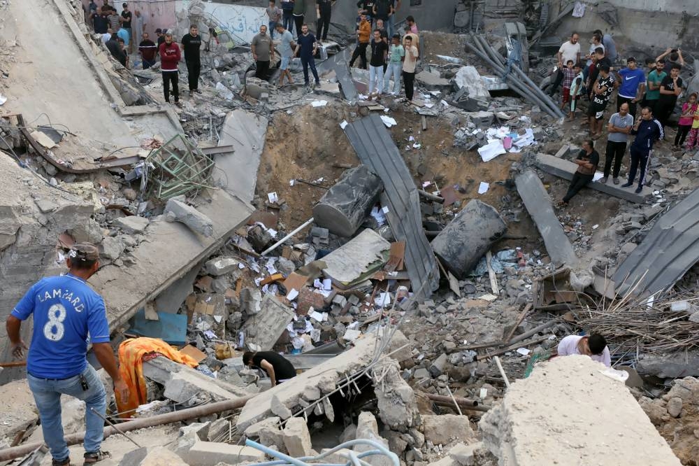 Palestinians search the destroyed annex of the Greek Orthodox Saint Porphyrius Church, the oldest church still in use in Gaza, damaged in a strike on Gaza City Friday. AFP