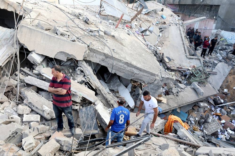 Palestinians search the destroyed annex of the Greek Orthodox Saint Porphyrius Church, the oldest church still in use in Gaza, damaged in a strike on Gaza City  Friday. AFP