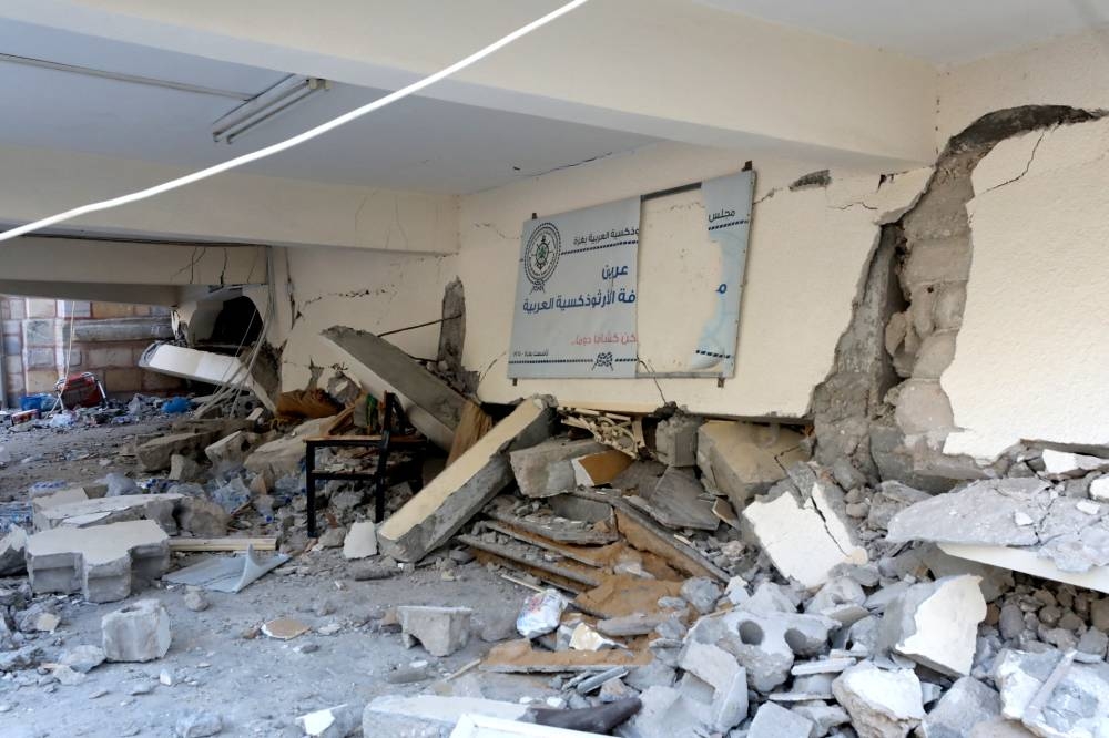 The cracked walls and debris litter the ground a day after the Greek Orthodox Saint Porphyrius Church, the oldest church still in use in Gaza, was damaged in a strike on Gaza City on Friday. AFP