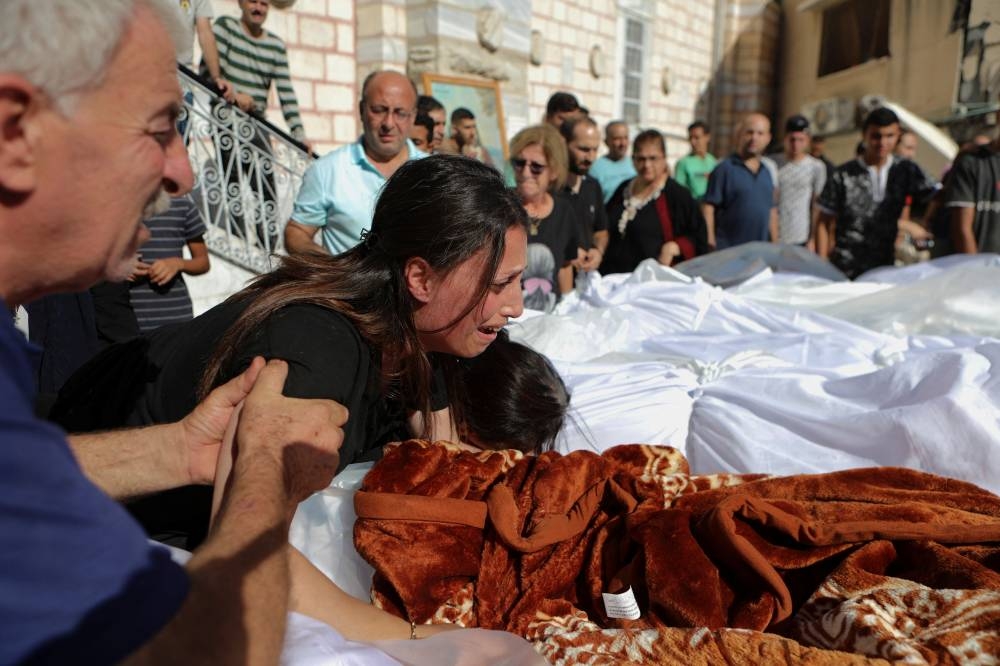 Worshippers attend a funeral for Palestinians killed in an Israeli strike that damaged the Greek Orthodox Saint Porphyrius Church, where Palestinians who fled their homes were taking shelter, at the church in Gaza City, Friday. REUTERS