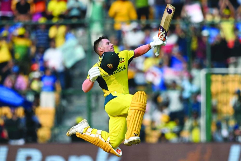 Australia’s David Warner celebrate after scoring a century against Pakistan during the ICC Cricket World Cup ODI match in Bengaluru on Friday. (AFP)