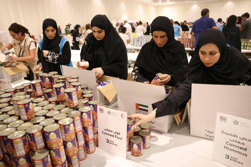 Volunteers help pack aid for the Gaza Strip at a donation centre set-up by the Emirates Red Crescent in Dubai on on Saturday. AFP