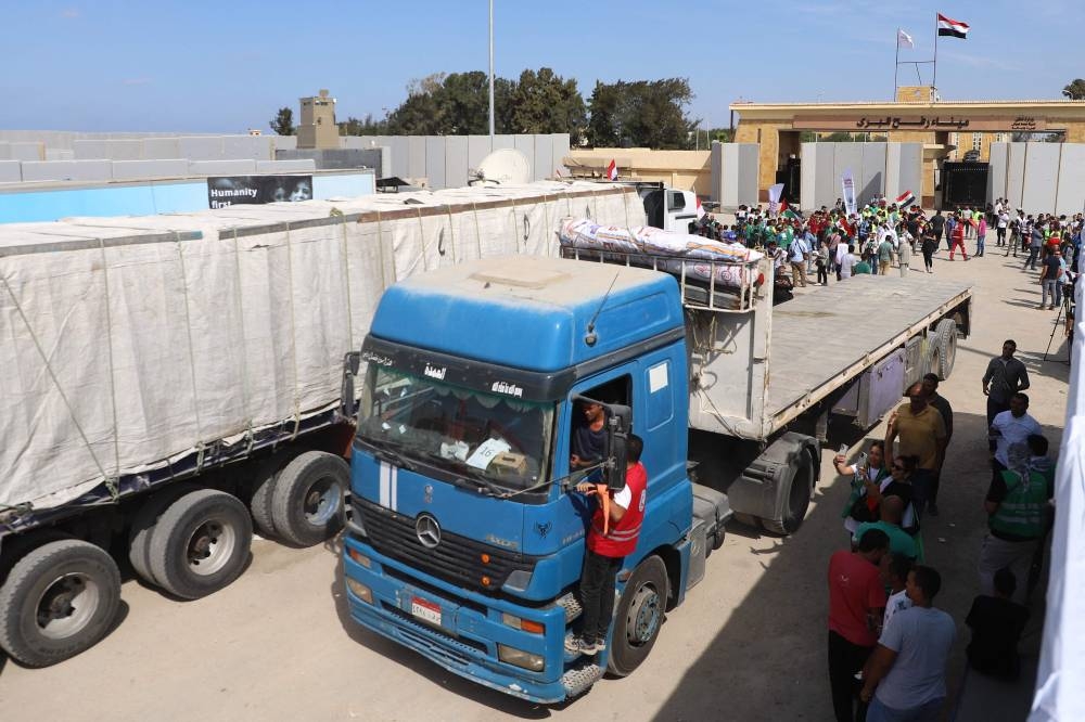 An aid truck is greeted by aid workers upon crossing back into Egypt through the Rafah border crossing with the Gaza Strip on on Saturday. AFP