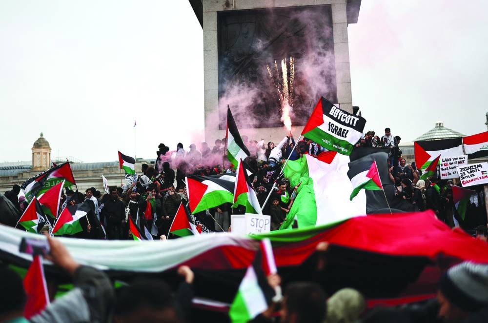 People take part in a 'March For Palestine', in London on October 21, 2023, to "demand an end to the war on Gaza". The UK has pledged its support for Israel following the bloody attacks by Hamas, which killed more than 1,400 people, and has announced that humanitarian aid to the Palestinians will be increased by a third -- an extra ｣10 million pounds ($12 million). Israel is relentlessly bombing the small, crowded territory of Gaza, where more than 3,400 people have been killed, most of them Palestinian civilians, according to the local authorities. (Photo by HENRY NICHOLLS / AFP)