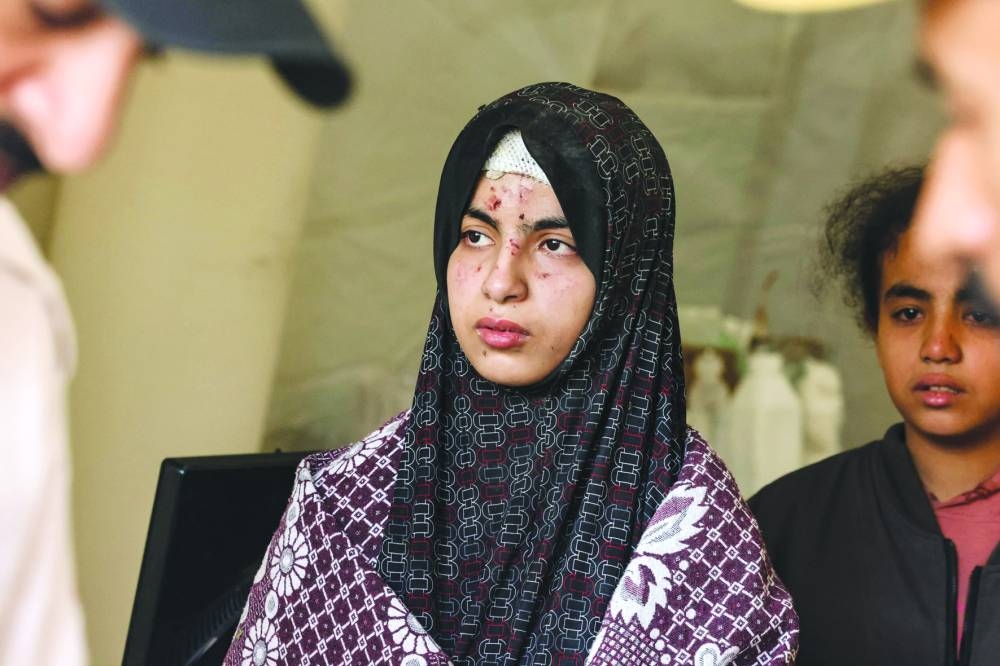 
A young injured woman is pictured in a hospital, following an Israeli bombardment in Rafah in the southern Gaza Strip, yesterday. 