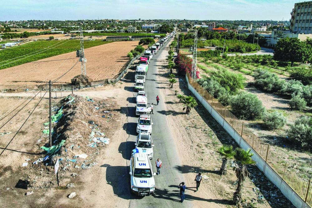 
This aerial view shows humanitarian aid trucks arriving from Egypt after having crossed through the Rafah border crossing at a storage facility in Khan Yunis in the southern Gaza Strip, yesterday. 