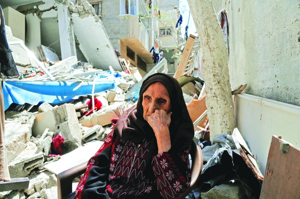 
Palestinian woman Intisar Muhana, 97, who was forced to flee al-Masmiyya village during the ‘Nakba’ in 1948 and whose house was destroyed in an Israeli strike in the recent Israel-Gaza fighting, sits in front of the rubble of her house, in Gaza City, on May 14, 2023. 