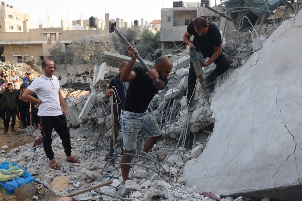 Palestinians dig through the rubble of a building after Israeli strikes on Rafah in the southern Gaza Strip on Sunday. AFP