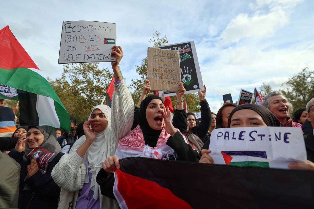 Protestors chant as they gather at Place de la Republique during a demonstration calling for peace in Gaza in Paris, Sunday. AFP
