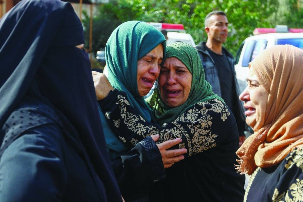 
Mourners attend the funeral of Palestinians from the al-Astal family, who were killed in Israeli strikes, in Khan Yunis, yesterday. 
