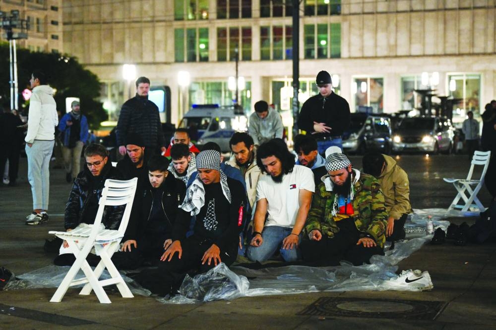 
People pray after a pro-Palestinian assembly at Alexanderplatz, amid the ongoing conflict, in Berlin, Germany, yesterday. 