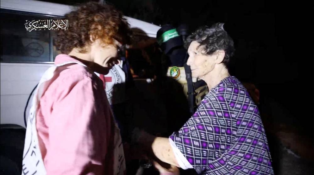Yocheved Lifshitz and Nurit Cooper (also known as Nurit Yitzhak, not pictured) who were held hostages by Palestinian Hamas militants, are released by the militants, in this video screengrab obtained by Reuters on Monday.  Al-Qassam Brigades, military wing of Hamas/Handout via REUTERS