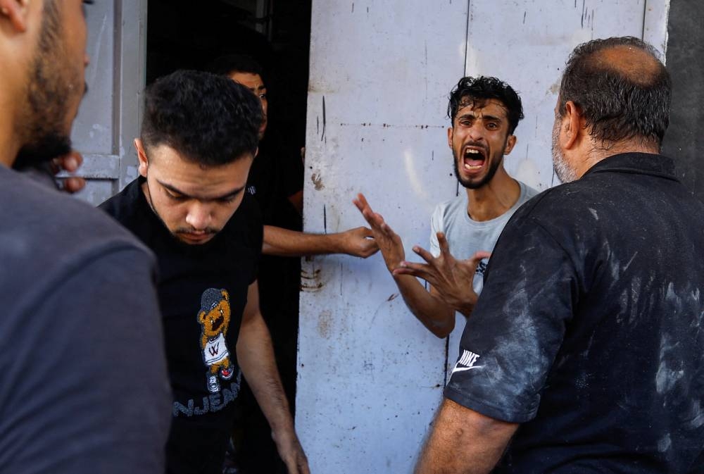 A man reacts at the site of an Israeli strike on a house, in Khan Younis, in the southern Gaza Strip, on Tuesday. REUTERS