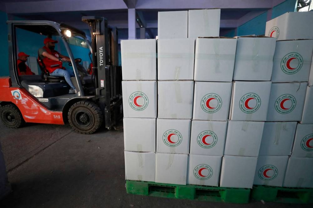 Iraqi Red Cresent Society employees pack humanitarian aid bound for the Palestinians of the Gaza Strip, at a warehouse in Baghdad on October 23. AFP