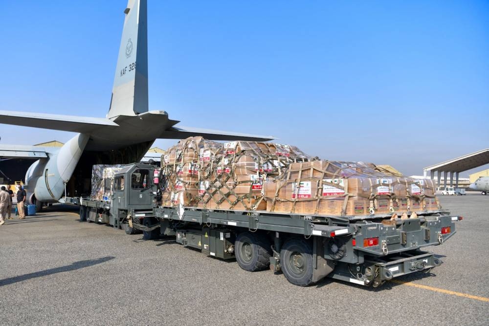 A handout photo released by the Kuwaiti news agency KUNA shows humanitarian aid, bound for Gaza through Egypt, being loaded into a military aircraft at the International Airport in Kuwait City on Tuesday.  KUNA / AFP