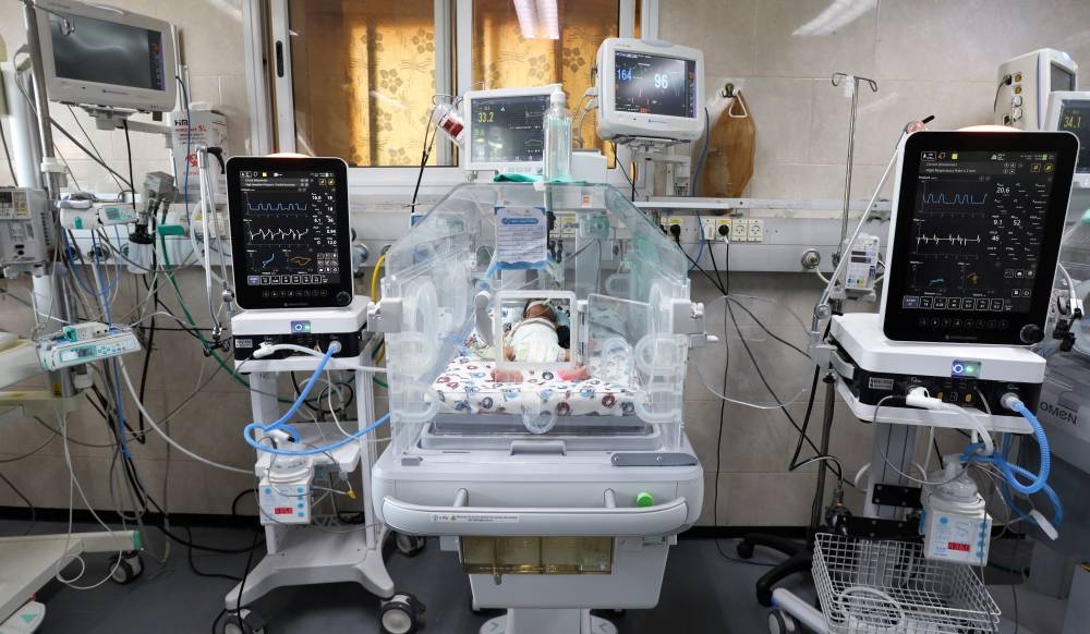 A premature Palestinian baby lies in an incubator at the maternity ward of Shifa Hospital, which according to health officials is about to shut down as it runs out of fuel and power, as the conflict between Israel and the Palestinian Islamist group Hamas continues, in Gaza City Sunday. REUTERS