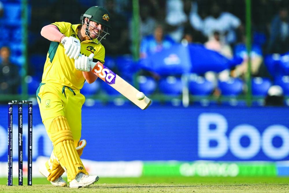Australia’s David Warner goes over the top en route to his second successive century during the World Cup match against the Netherlands on Wednesday. (AFP)