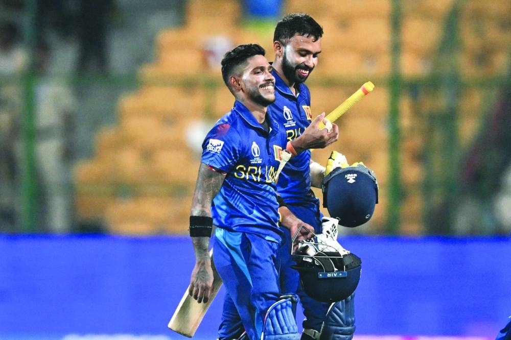 Sri Lanka’s Sadeera Samarawickrama (right) and Pathum Nissanka walk back to the pavilion after winning the World Cup match against England at the M. Chinnaswamy Stadium in Bengaluru on Thursday. (AFP)