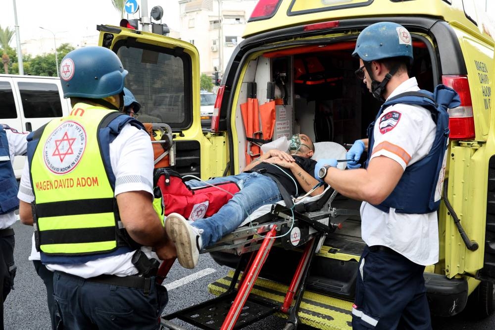 A man is ferried to an ambulance following a rocket attack from the Palestinian Gaza Strip on the city of Tel Aviv on Friday. AFP