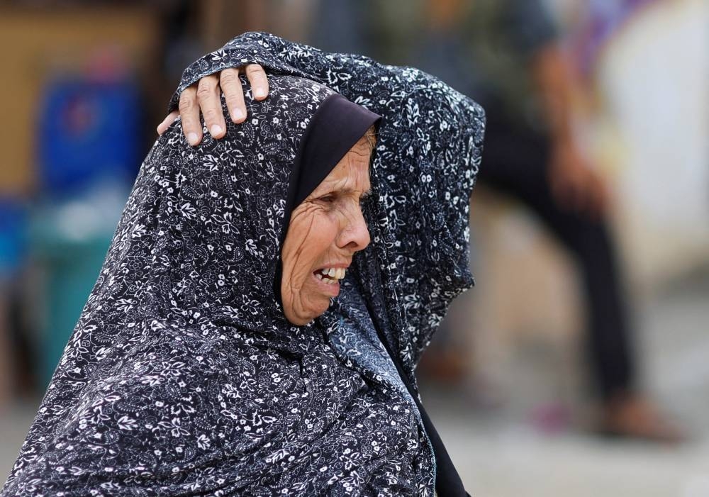 A woman reacts at the site of an Israeli air strike on a house in Khan Younis in the southern Gaza Strip, Friday. REUTERS