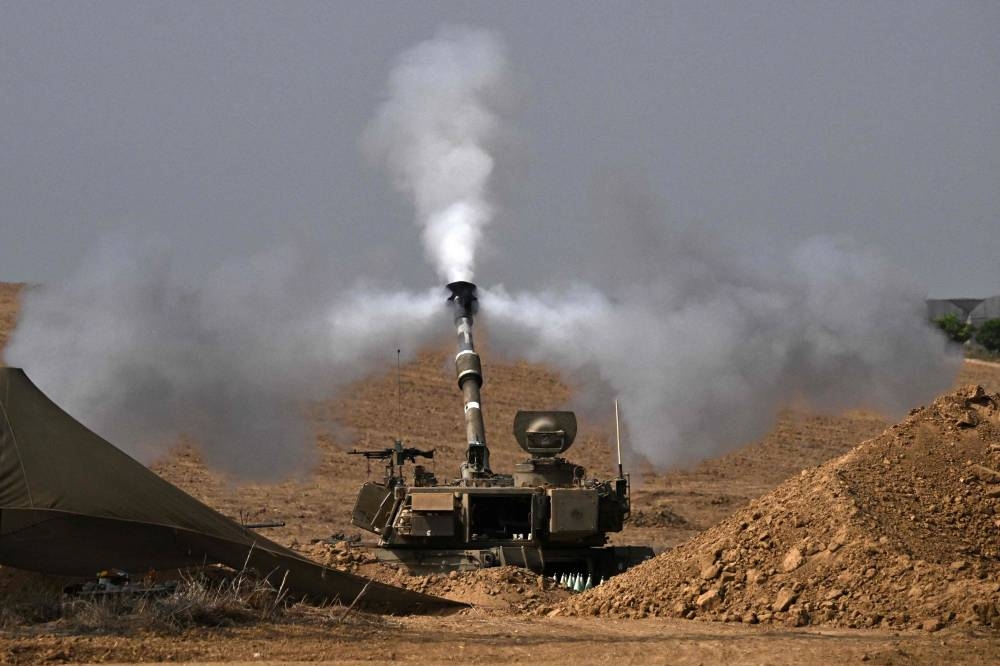 An Israeli army M109 155mm self-propelled howitzer fires rounds toward the Gaza Strip from a position in southern Israel across the border on October Saturday. AFP