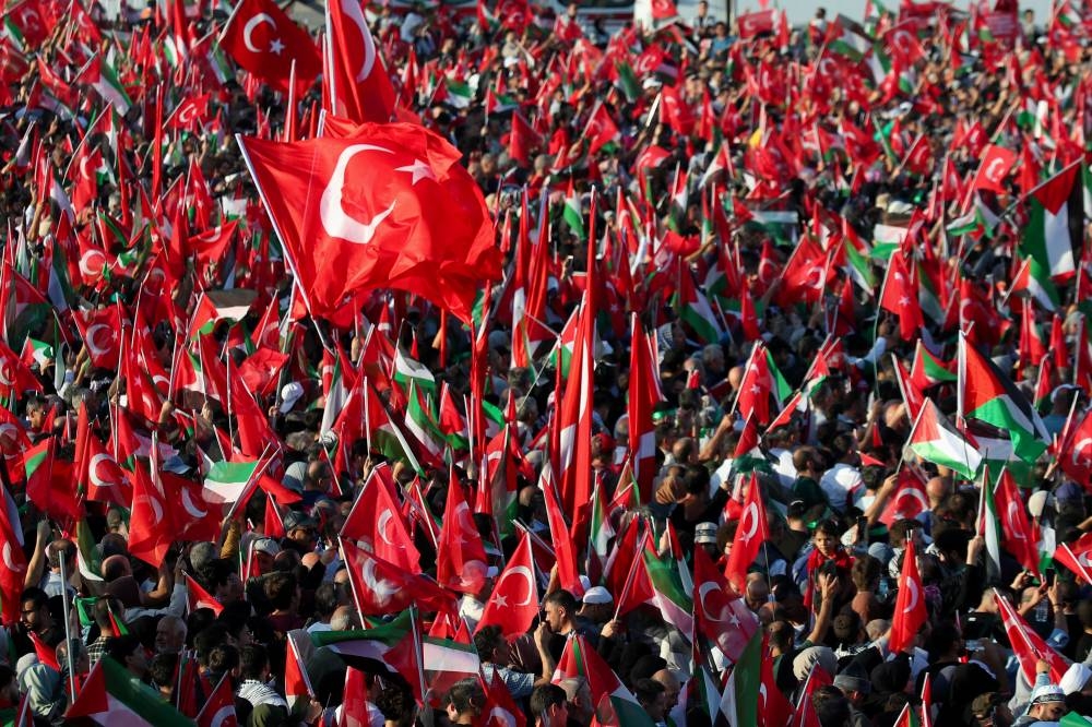 People attend a rally in solidarity with Palestinians in Gaza in Istanbul, Turkey Saturday. REUTERS