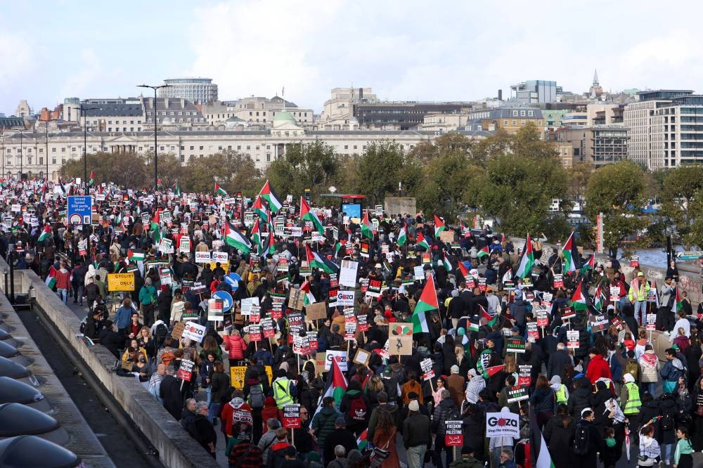Demonstrators protest in solidarity with Palestinians in Gaza, in London, Britain, Saturday. REUTERS