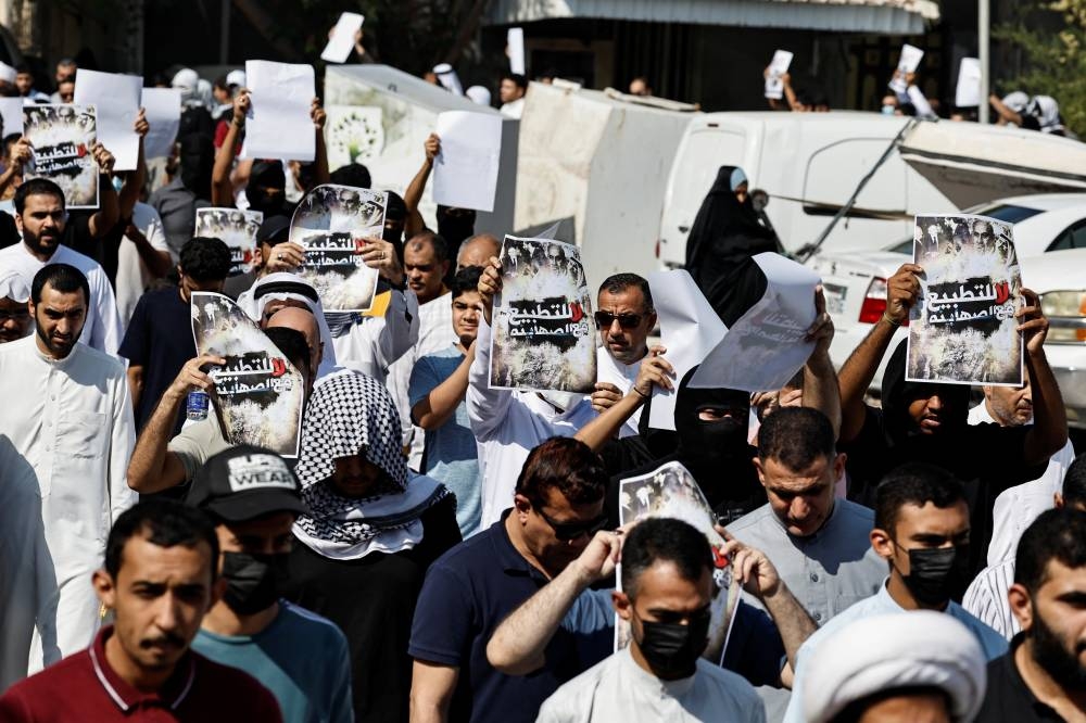 Protesters hold banners during a protest in support of Palestinians in Gaza, in the village of Diraz, Bahrain, Friday. REUTERS