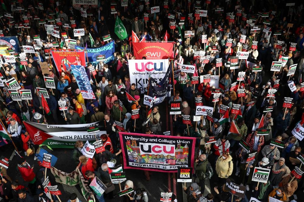 Demonstrators protest in solidarity with Palestinians in Gaza, in London, Britain, Saturday. REUTERS