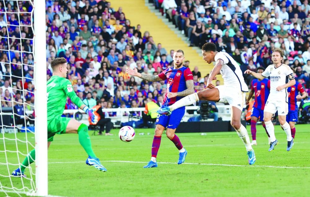 Real Madrid’s Jude Bellingham scores against Barcelona in the La Liga on Saturday. (Reuters)