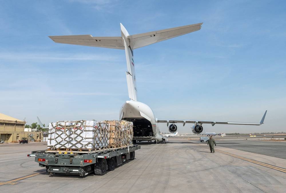 Humanitarian aid bound for the Gaza Strip through Egypt's northern Rafah border crossing, being loaded into a military aircraft at the International Airport in Kuwait City. AFP/KUNA
