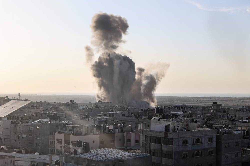 Smoke and dust rise following an Israeli air strike in Rafah, in the southern Gaza Strip on Monday. AFP