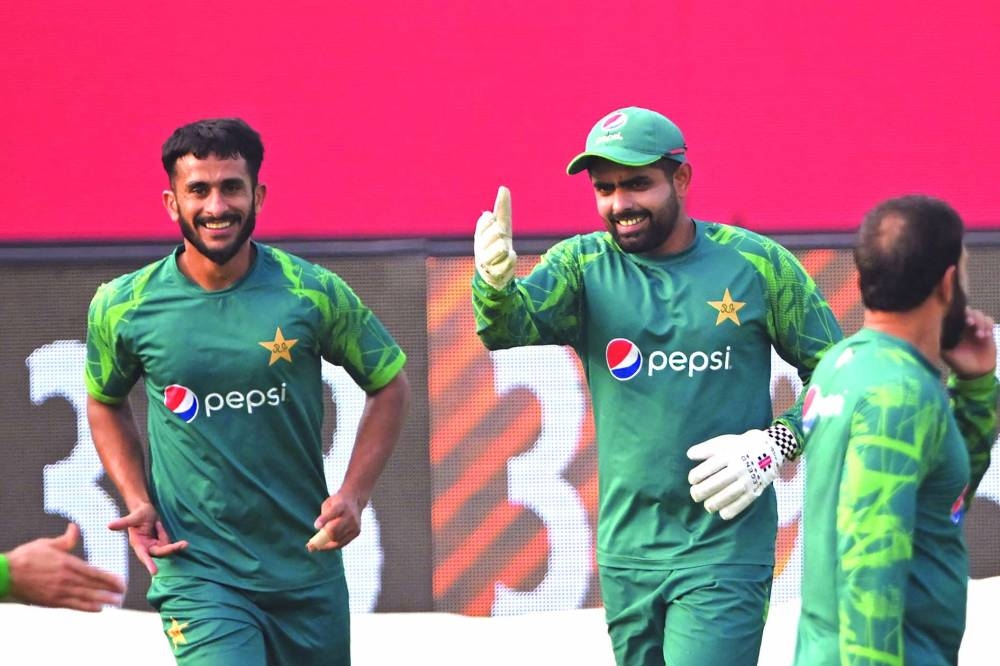 Pakistan’s captain Babar Azam (centre) and Hasan Ali attend a practice session on Monday, on the eve of their  World Cup match against Bangladesh in Kolkata on Monday. (AFP)