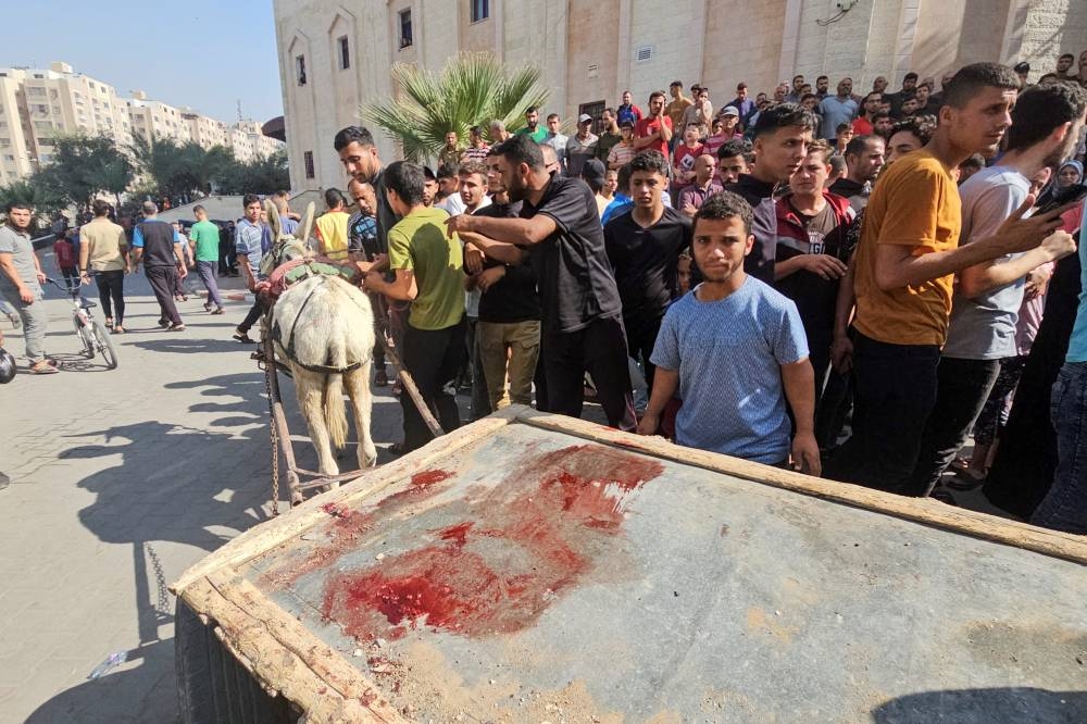 A donkey-drawn cart used to transport bodies of Palestinians killed by Israeli forces during Israel's ground invasion is stained with blood, near a hospital in Beit Lahiya in the northern Gaza Strip Tuesday. REUTERS