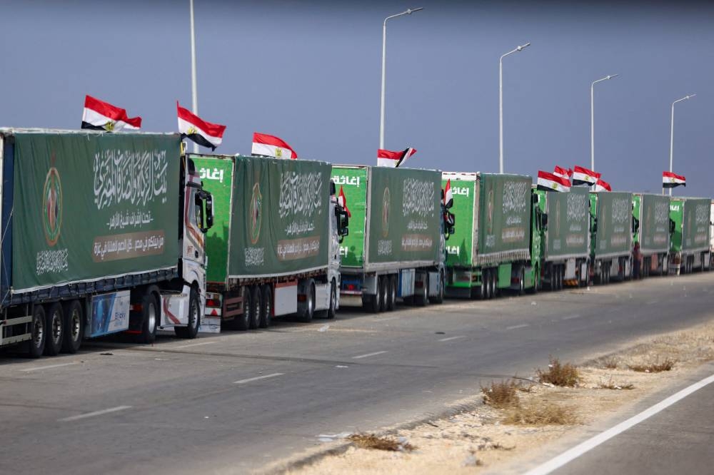 Trucks carrying humanitarian aid for Palestinians, are seen on the day of Egyptian Prime Minister Mostafa Madbouly's visit to the Rafah border crossing between Egypt and the Gaza Strip, in Rafah, Egypt, on Tuesday. REUTERS