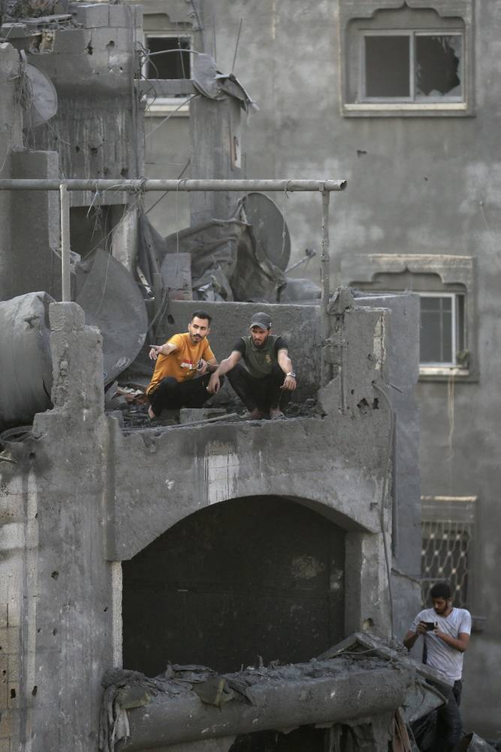 Palestinians gesture as they check the destruction in the aftermath of an Israeli strike in the Jabalia camp for Palestinian refugees in the Gaza Strip, on Wednesday. AFP