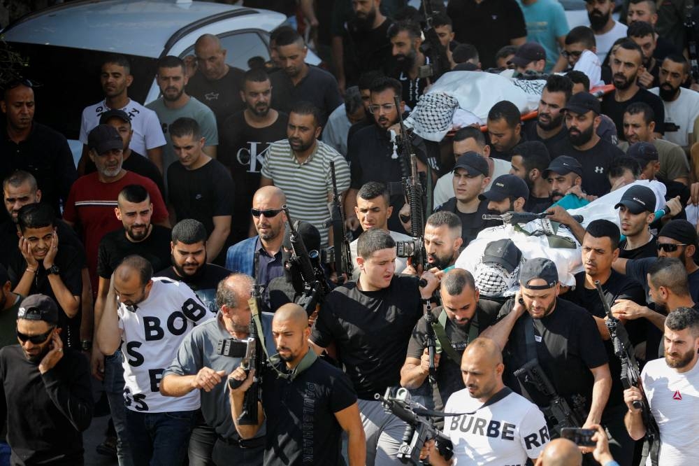 Mourners carry bodies of Palestinians who were killed in an Israeli raid, at the Jenin refugee camp, in Jenin in the Israeli-occupied West Bank, , Wednesday. REUTERS