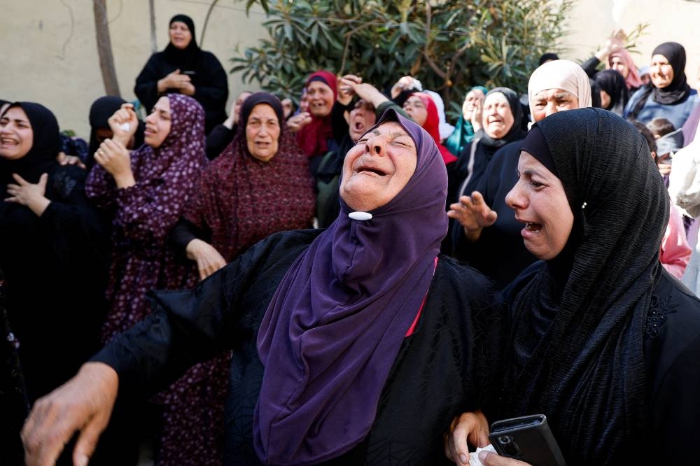 Friends and family mourn Rawhe Sawafta, 70, at his funeral in Tubas, in the Israeli-occupied West Bank Tuesday. REUTERS
