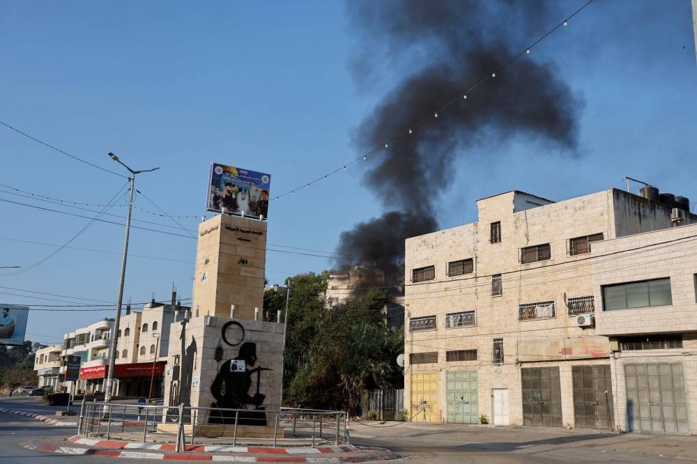 Smoke appears following an Israeli raid in Jenin in the Israeli-occupied West Bank, Wednesday. REUTERS