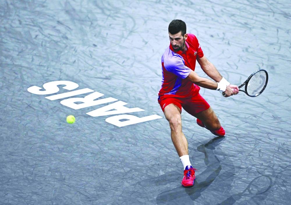 Serbia’s Novak Djokovic plays a backhand return to Argentina’s Tomas Martin Etcheverry during the Paris Masters on Wednesday. (AFP)