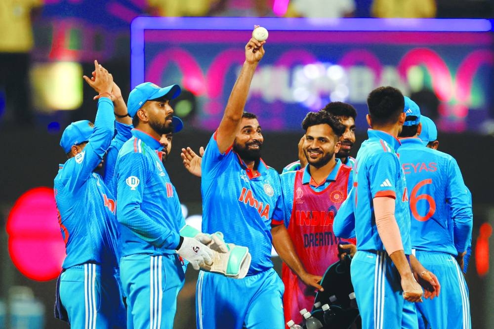 India’s Mohamed Shami (centre) celebrates after taking five wickets on Thursday. (AFP)