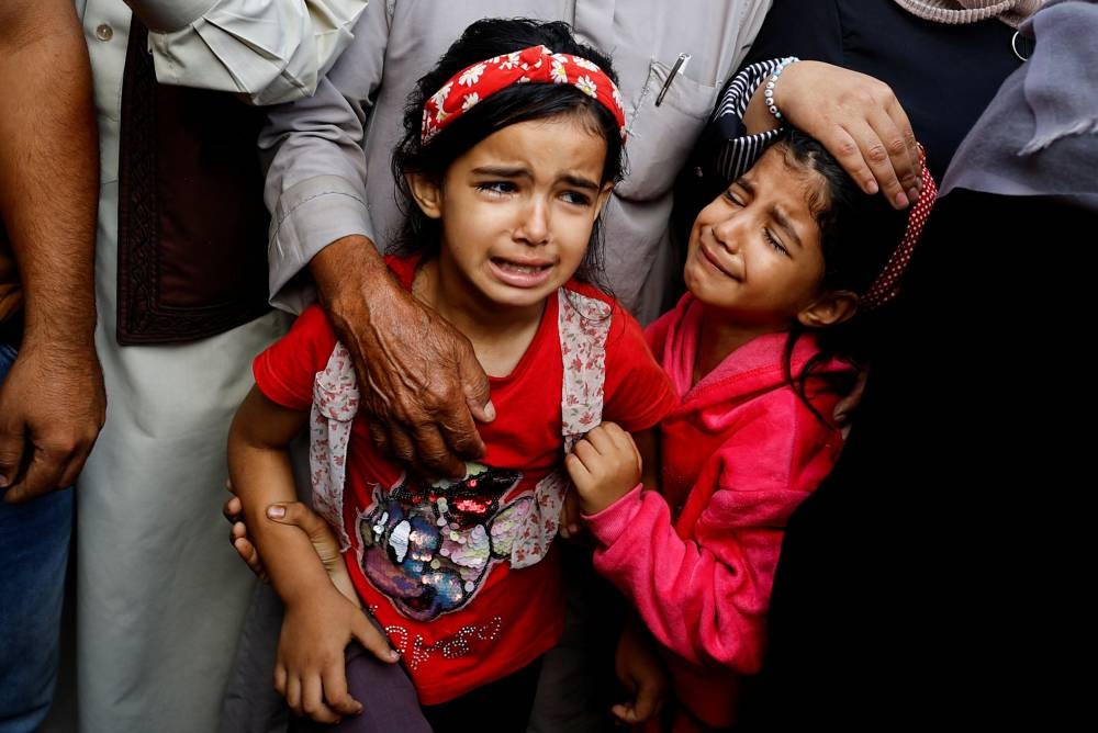 Young girls mourn the Palestinians killed during Israeli strikes at a hospital, in Khan Younis in the southern Gaza Strip, on Friday. REUTERS