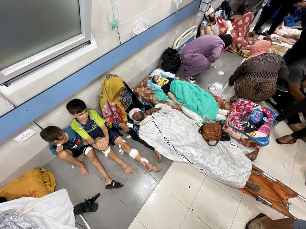  Palestinians who were wounded after a convoy of ambulances was hit, are assisted at Shifa hospital in Gaza City, Friday. REUTERS