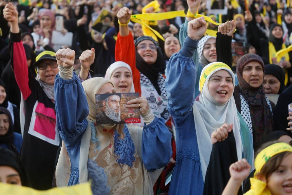 Supporters of Lebanon's Hezbollah leader Sayyed Hassan Nasrallah gather to watch his address during a ceremony to honour fighters killed in the recent escalation with Israel, in Beirut's southern suburbs, Lebanon, Friday REUTERS