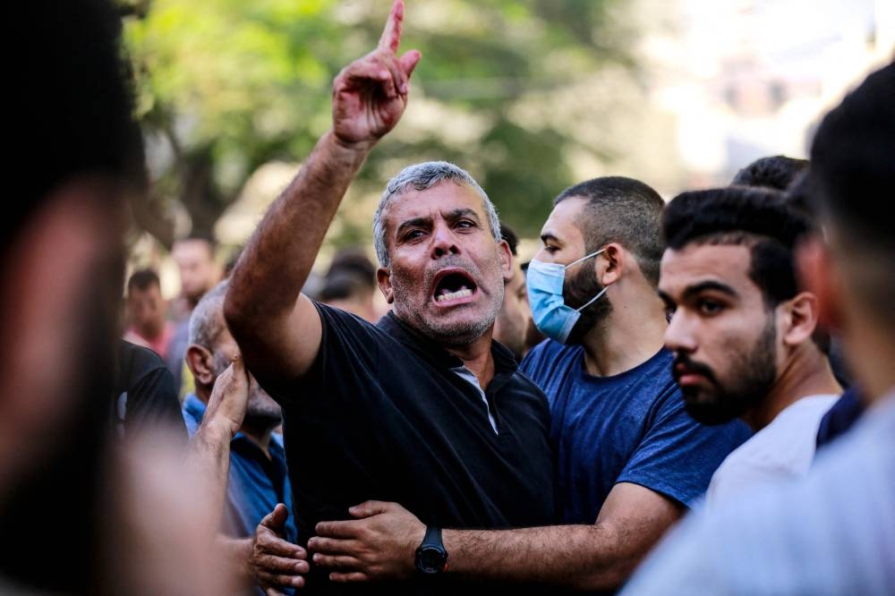 The relative of a victim killed a day earlier in an Israeli strike that hit the entrance of Al-Shifa hospital in Gaza City, reacts during a funeral held for the victims on Saturday. AFP