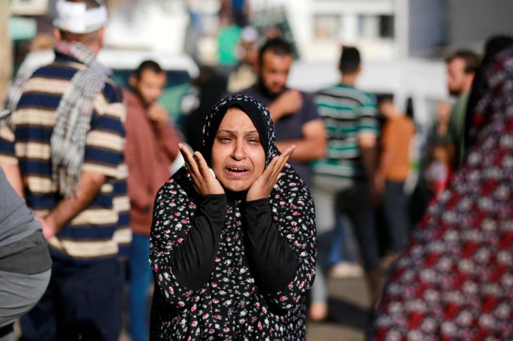 The relative of a victim killed a day earlier in an Israeli strike that hit the entrance of Al-Shifa hospital in Gaza City, reacts during a funeral held for the victims on Saturday. AFP