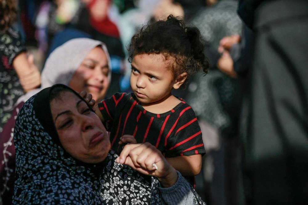 The relative of a victim killed a day earlier in an Israeli strike that hit the entrance of Al-Shifa hospital in Gaza City, reacts during a funeral held for the victims on Saturday. AFP